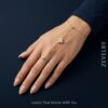 Gold Stainless Steel Hand Chain – Aurelia Clover Hand Chain ZEVELRY Model wearing Gold Stainless Steel Hand Chain – Aurelia Clover Hand Chain ZEVELRY